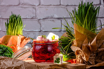 Traditional ukrainian russian soup borscht with greens and sour cream. Beetroot soup in bowl on white wooden background. Top view, flat lay