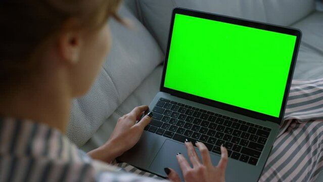 Woman waving green laptop at home closeup. Student videocalling family weekend