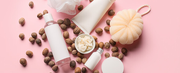 Composition with shea butter and bath supplies on pink background
