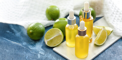 Bottles of lime essential oil on table