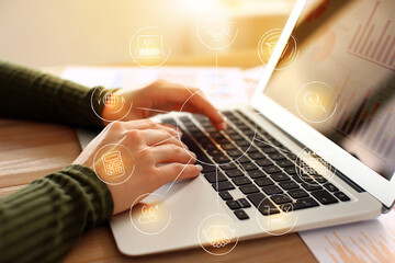 Businesswoman working with laptop at table in office, closeup. Concept of marketing strategy