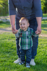 Little boy is learning to walk. Childhood background.