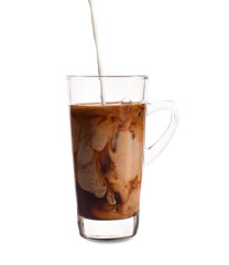 Pouring of milk into glass cup with iced coffee on white background