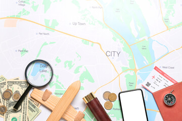Fototapeta na wymiar Guide's belongings with wooden airplane on city map