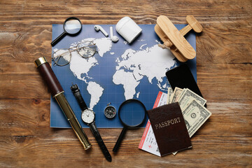 Guide's belongings with world map and magnifiers on wooden background