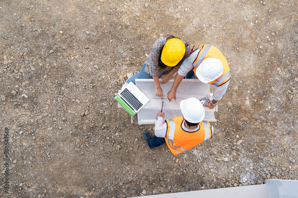 Poster high angle view of architect and engineer meeting planning for a new project about detail of buildin