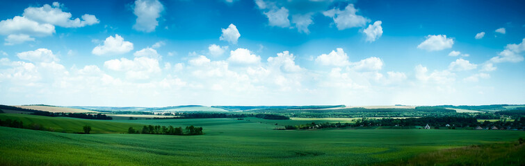 Ukrainian landscape with fields behind the blue sky