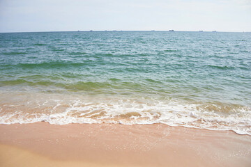 Sand and beach with frothy wave