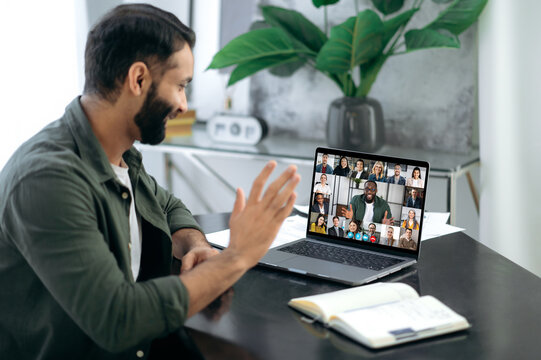 Online conversation. Online business meeting, brainstorm of employees. Indian successful man, ceo, talking on video conference call with colleagues of different nationalities, discussing the project