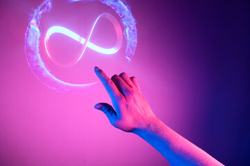 Hand of men pointing on endless infinity sign of virtual reality metaverse digital innovation game...
