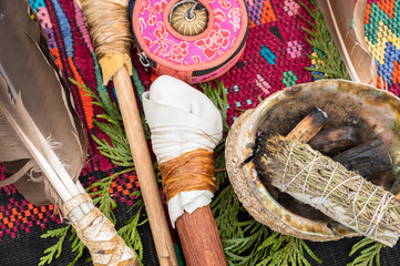 A bundle of sage and an eagle feather are laid out in preparation of a Native American, Indian, or...