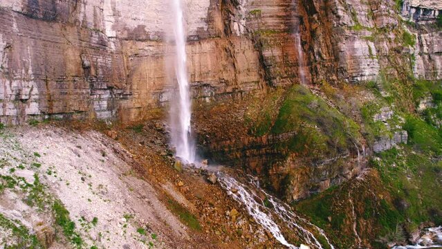 Majestic panorama of a huge cliff with waterfall, drone shot. High quality 4k footage