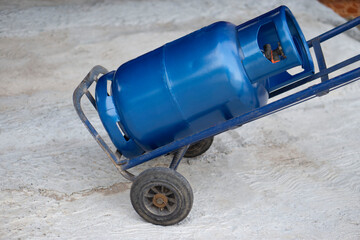 Blue LPG gas cylinder tank on small cart to make delivery to local customers in rural of Thailand....