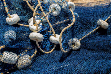 Detail of a fisherman's net on the ground.