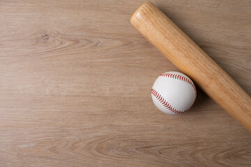 Close up baseball and baseball bat on wooden table with copy space background, sport concept