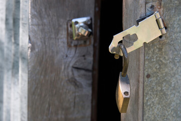 A padlock hanging from an open door