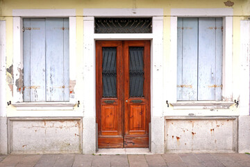 Fototapeta na wymiar House facade with closed door windows