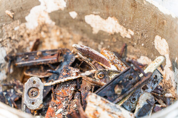 Diverse old rusty scrap metal from small items close-up