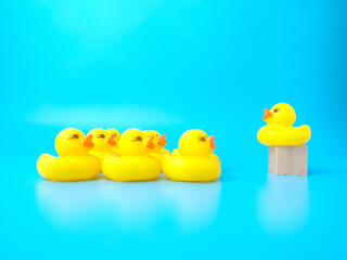 Group of toy ducks with leadder. Leadder and teamwork concept