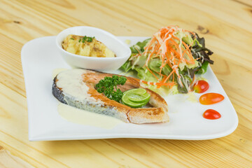 grilled salmon steak with mash potato and vegetable salad	