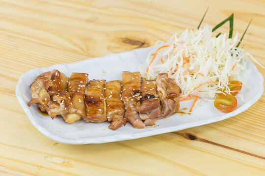 Toriyaki chicken rice on a plate, served with food photos, top view
