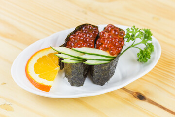 Japanese tradition food sushi Ikura, Gunkan sushi or salmon roe on japan rice rap by Seaweed