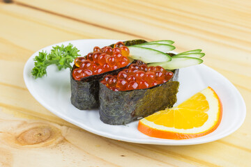 Japanese tradition food sushi Ikura, Gunkan sushi or salmon roe on japan rice rap by Seaweed