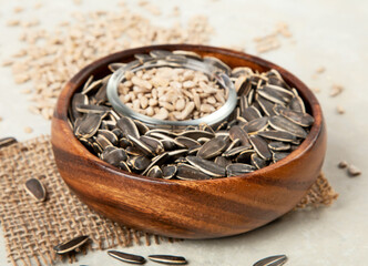 Sunflower oil and sunflower seeds on light background.
