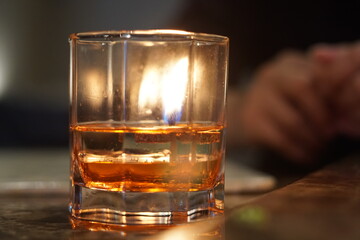 A candle in a glass on a restaurant's table