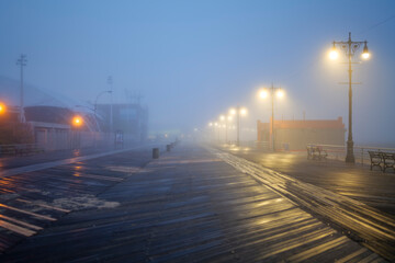 Fototapeta premium Street lights, foggy misty night, lamp post lanterns, deserted road in mist fog. High-quality photo