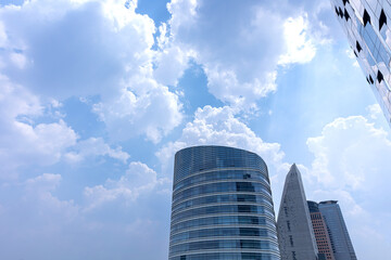 Fototapeta na wymiar building glass curtain wall and blue sky and white clouds