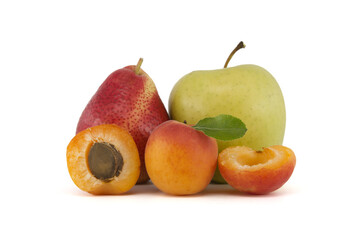 Whole and halved ripe apricot, pear and green apple