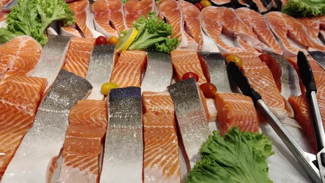 Close-up view of the fresh fjord trout fillet on the ais selling in the supermarket.