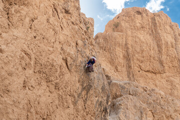 Experienced athlete on Israel Independence Day descending with equipment for rappel in mountains of...