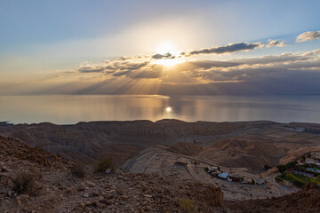 Sunrise  over the Dead Sea near mountains of stone desert near the Khatsatson stream, on the Israeli side of the Dead Sea, near Jerusalem in Israel