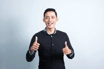 Fototapeta premium Attractive Asian man having different emotions with hand gesture indicating success