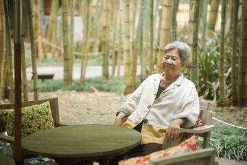 old elderly senior elder woman relaxing on terrace. retirement lifestyle