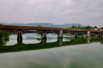 Fototapeta premium Covered wooden bridge over the Rhine River at Stein, Canton Aargau, and Bad Säckingen, Baden-Württemberg, on a cloudy spring day. Photo taken May 6th, 2022, Stein, Switzerland.