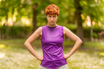 Non-binary gender person with angry expression in a park