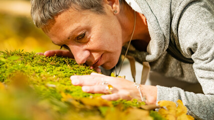 Mindfulness and grounding concept. Mindful woman practicing grounding technique in the forest,...