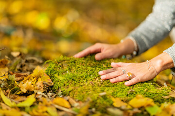 Female hands touching the ground, connecting to earth, grounding concept