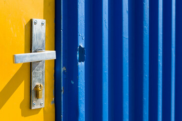 Bright yellow and blue painted door on a construction site