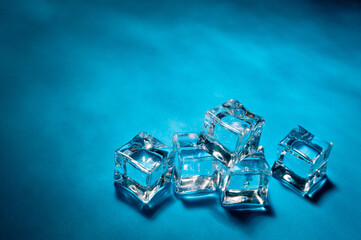 Clear ice cubes for cooling drinks on a blue background.