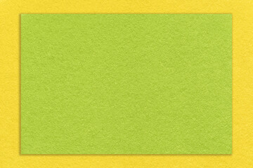 Texture of craft bright green paper background with yellow border, macro. Structure of vintage olive dense kraft cardboard.