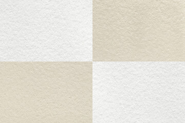 Fototapeta premium Texture of craft light beige and white paper background with cells pattern, macro. Structure of vintage kraft cardboard.