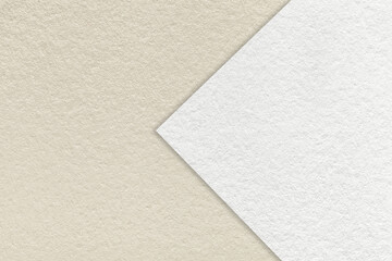 Texture of light beige and white paper background, half two color with arrow, macro. Structure of...