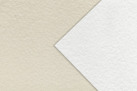 Texture of light beige and white paper background, half two color with arrow, macro. Structure of brown craft cardboard.