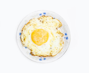 fried egg in a plate isolated on white background on top view. Food cooking
