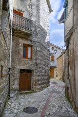 Fototapeta na wymiar A narrow street between the old houses of Petina, a village in the mountains of Salerno province, Italy.