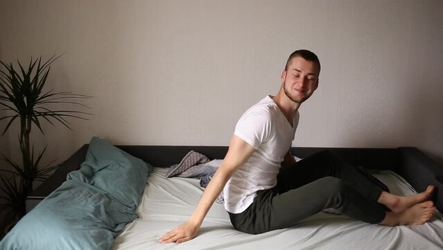 The guy bounces in bed